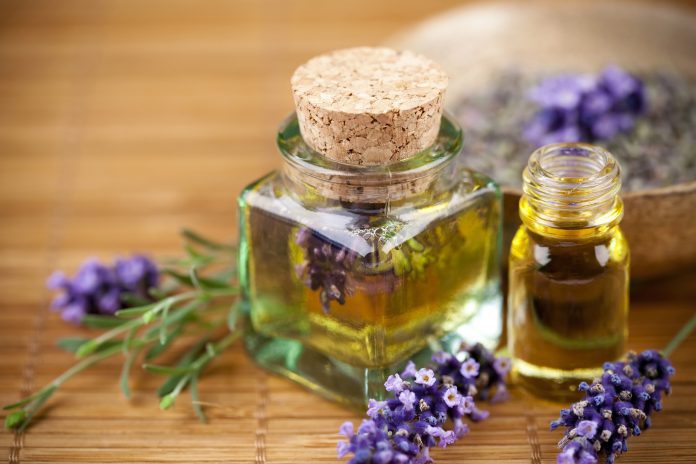 Bottle of lavender oil on table.